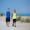Young Healthy Looking Couple Jogging Outdoor by Beach under Summer Sky.jpg